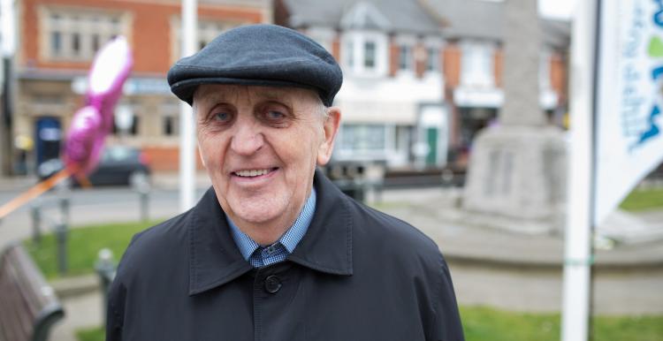 An elderly man wearing a hat smiling at the camera An elderly man wearing a hat smiling at the camera