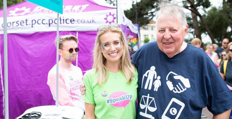 Woman and a man outside at an event enjoying the sun Woman and a man outside at an event enjoying the sun