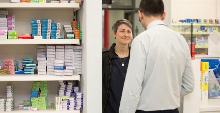 Person speaking to a pharmacist Person speaking to a pharmacist