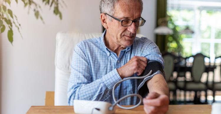 man taking his blood pressure man taking his blood pressure